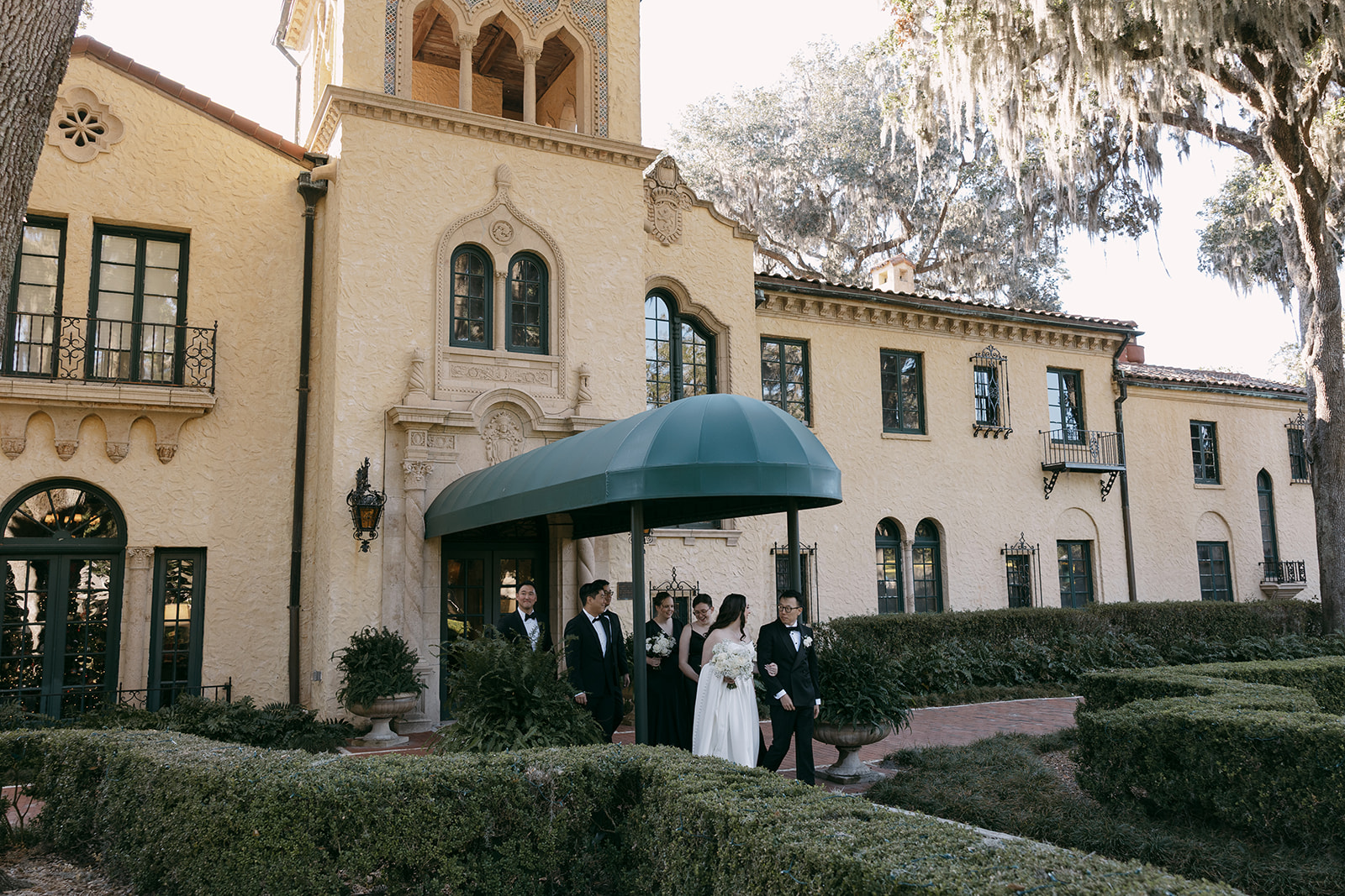 Groom in a bespoke tuxedo from TS Custom Suits standing at a luxury Northeast Florida wedding venue