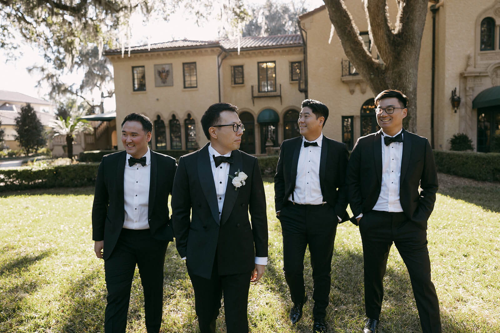 Groomsmen in coordinated custom suits and ties