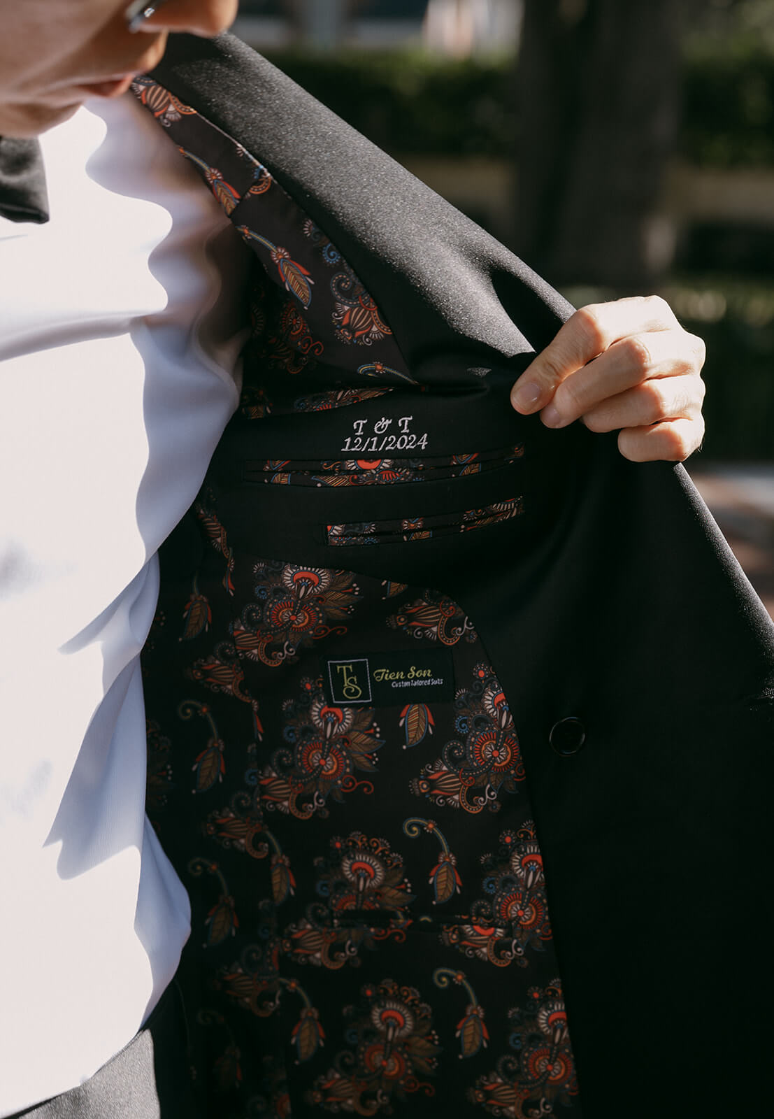 Engraved buttons and hand-stitched monogram detail